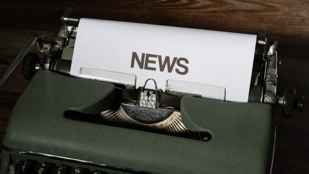 Close-up of a vintage typewriter with a newspaper, representing journalism at Hintpoint News
