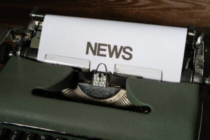 Close-up of a vintage typewriter with a newspaper, representing journalism at Hintpoint News